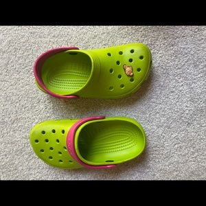 Lightly worn green and pink Crocs with nemo gibbet.